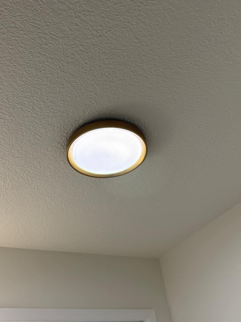 A ceiling light fixture installed in a neutral interior, highlighting modern design.