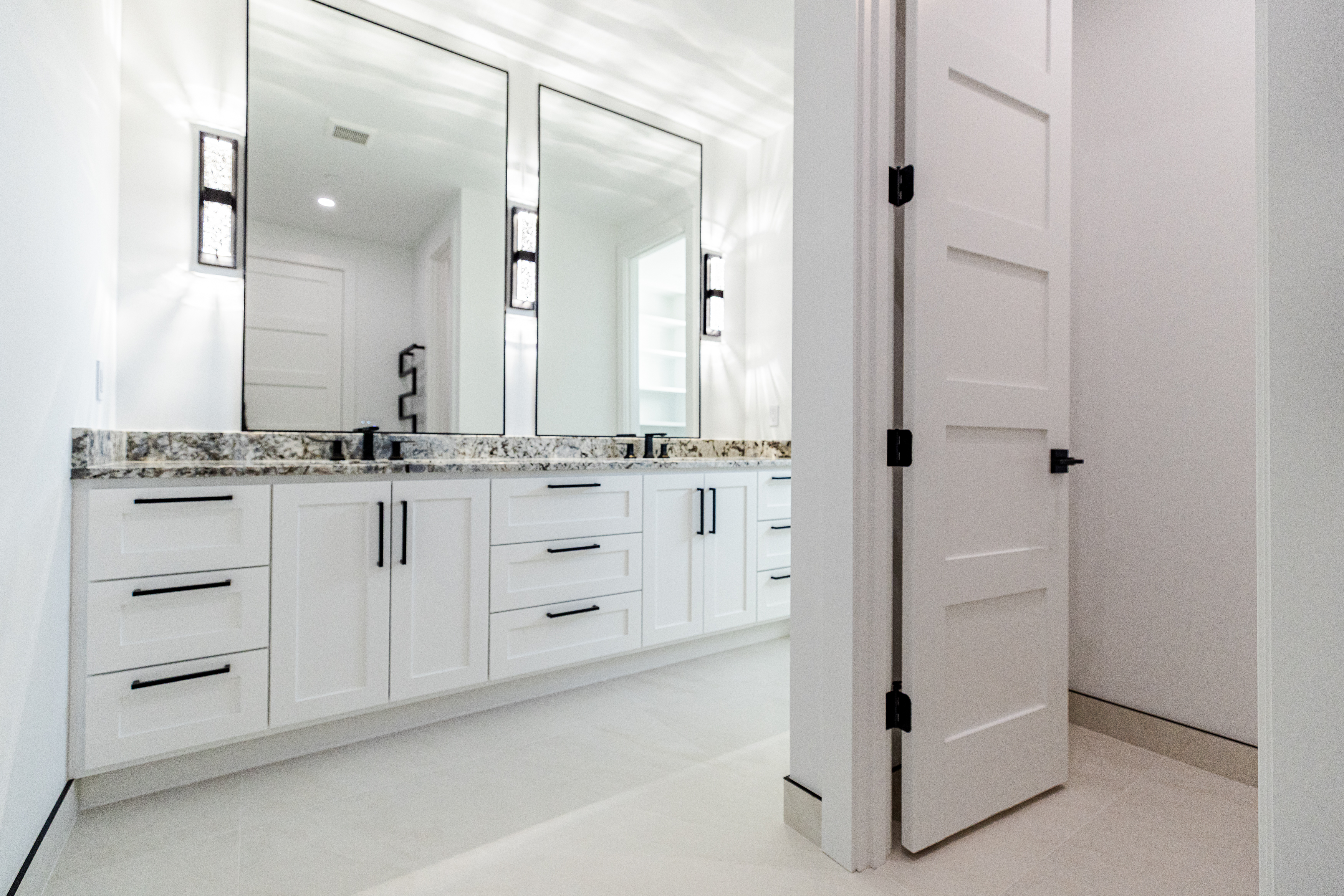 Primary bathroom electrical installation with vanity sconces and recessed lights