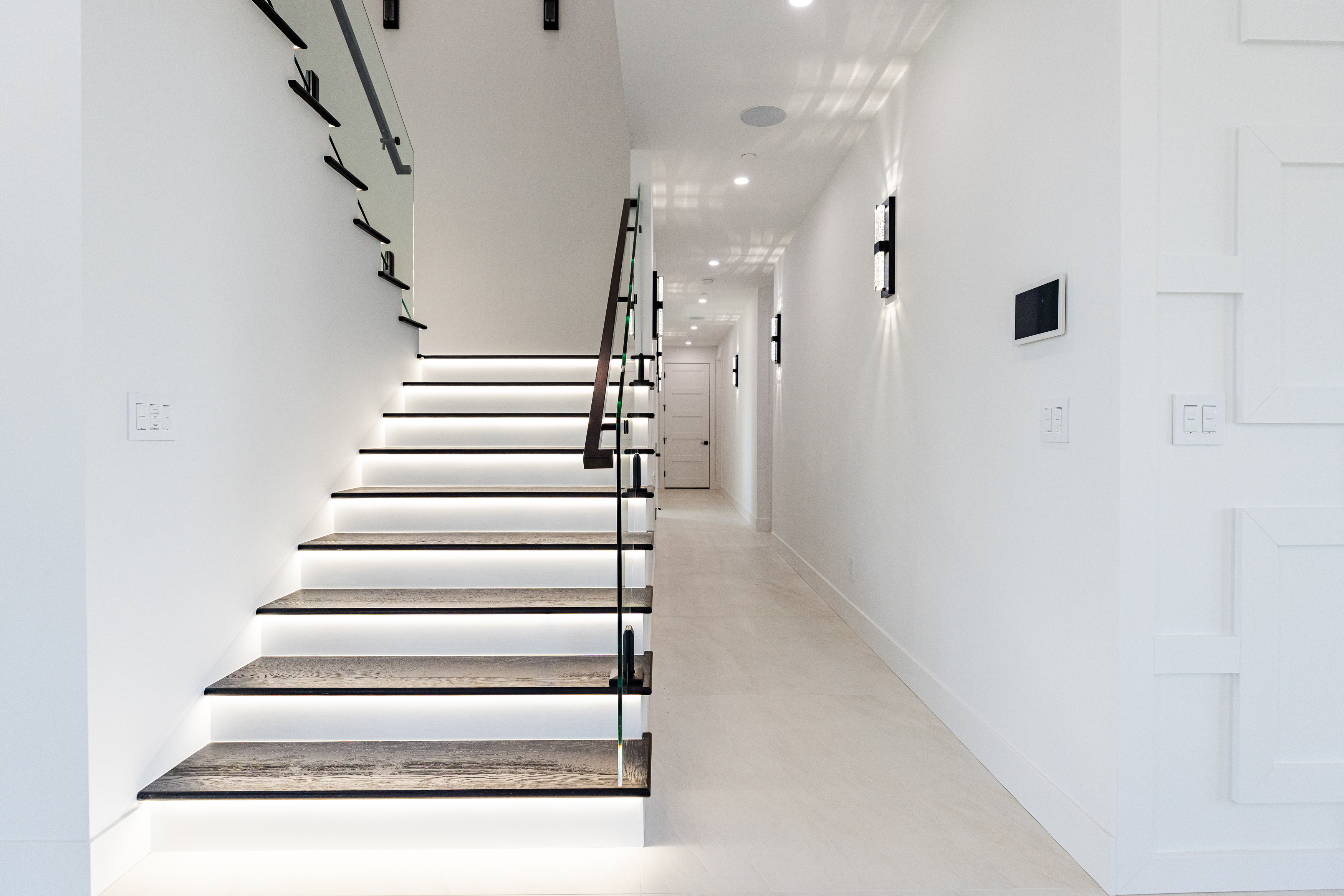 Modern staircase with integrated LED step lighting installed by Power Professors