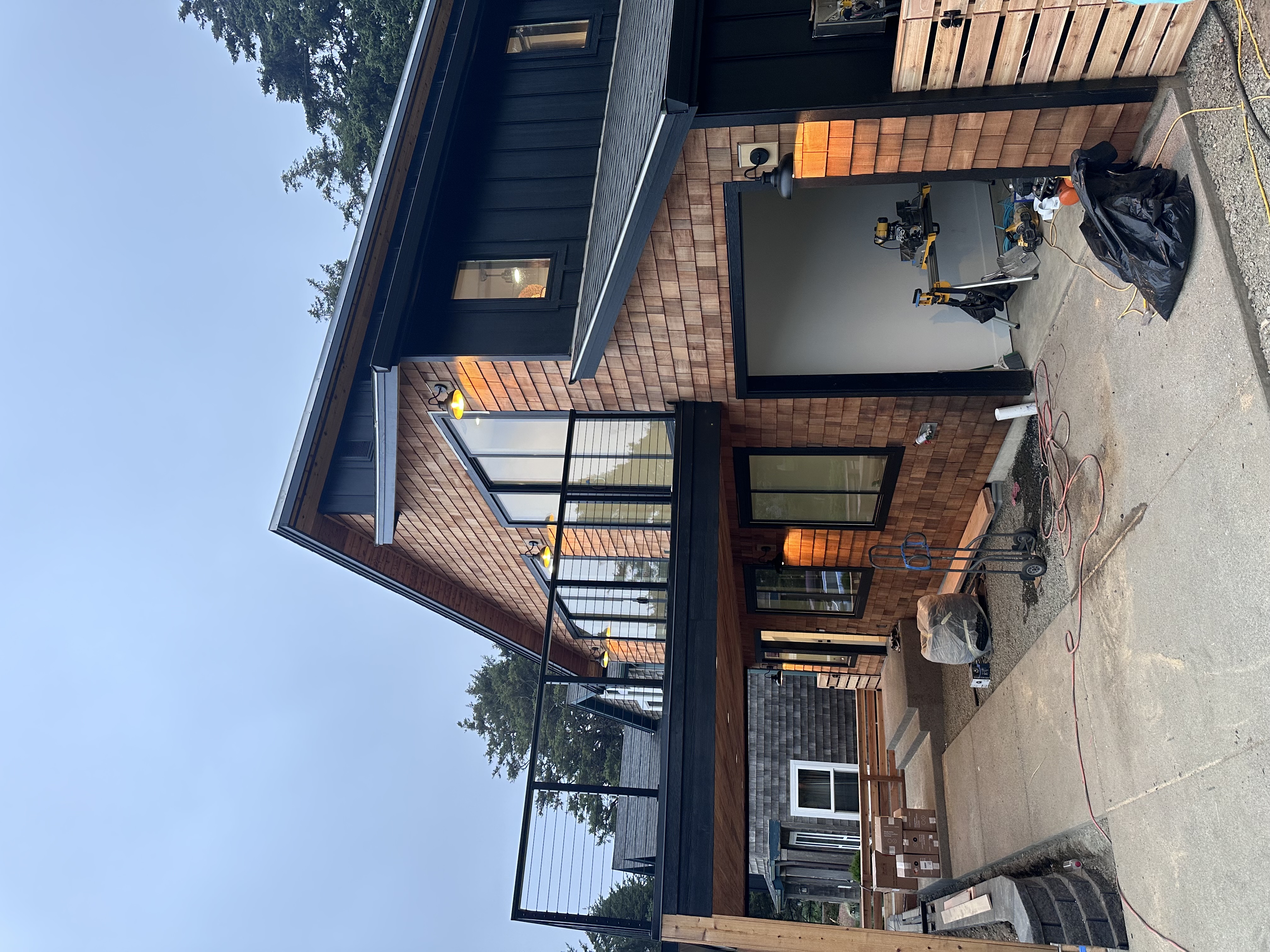 Residential exterior electrical installation on a cedar-sided home