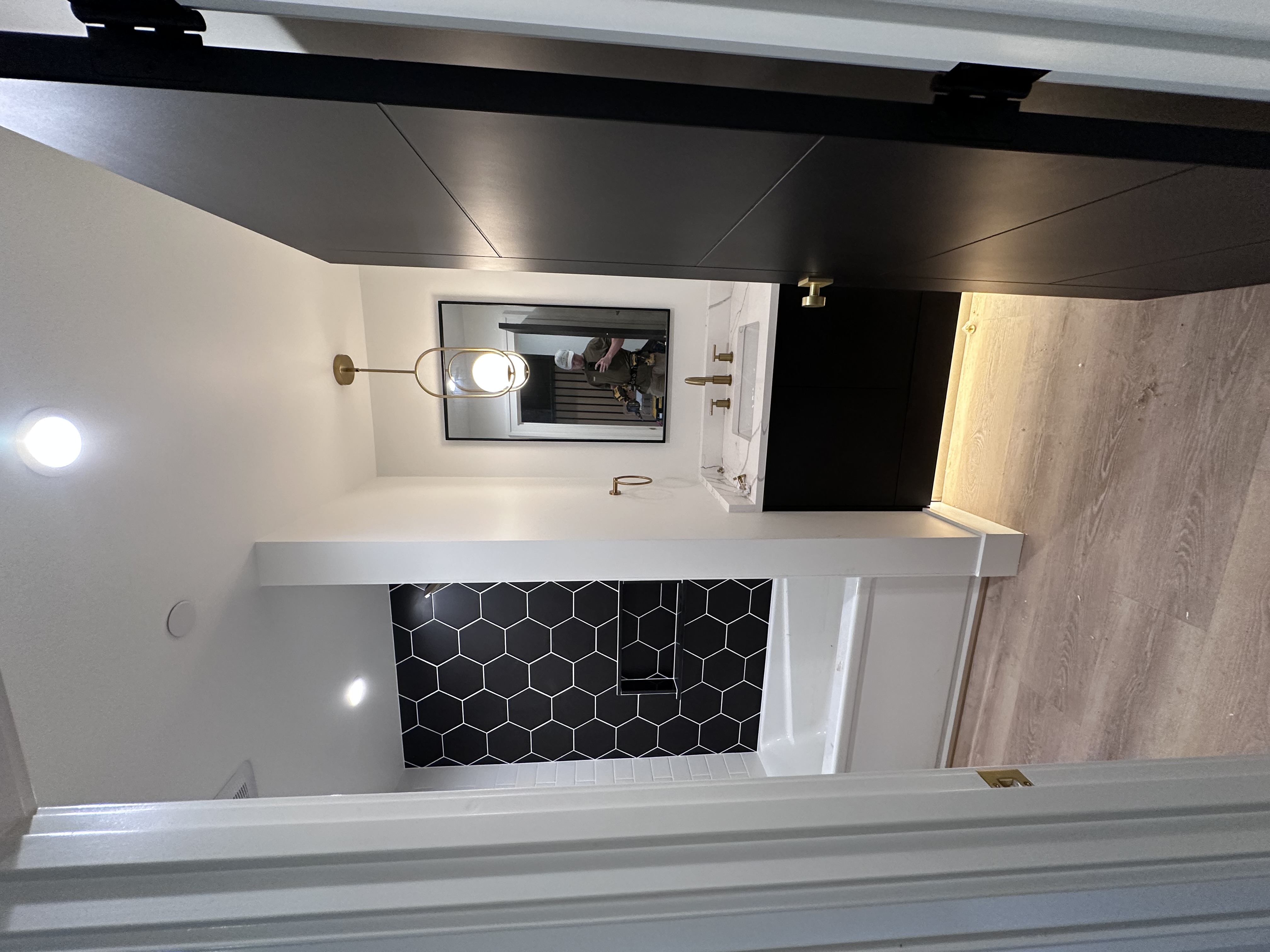 Modern bathroom with pendant lighting, recessed lights, and illuminated vanity