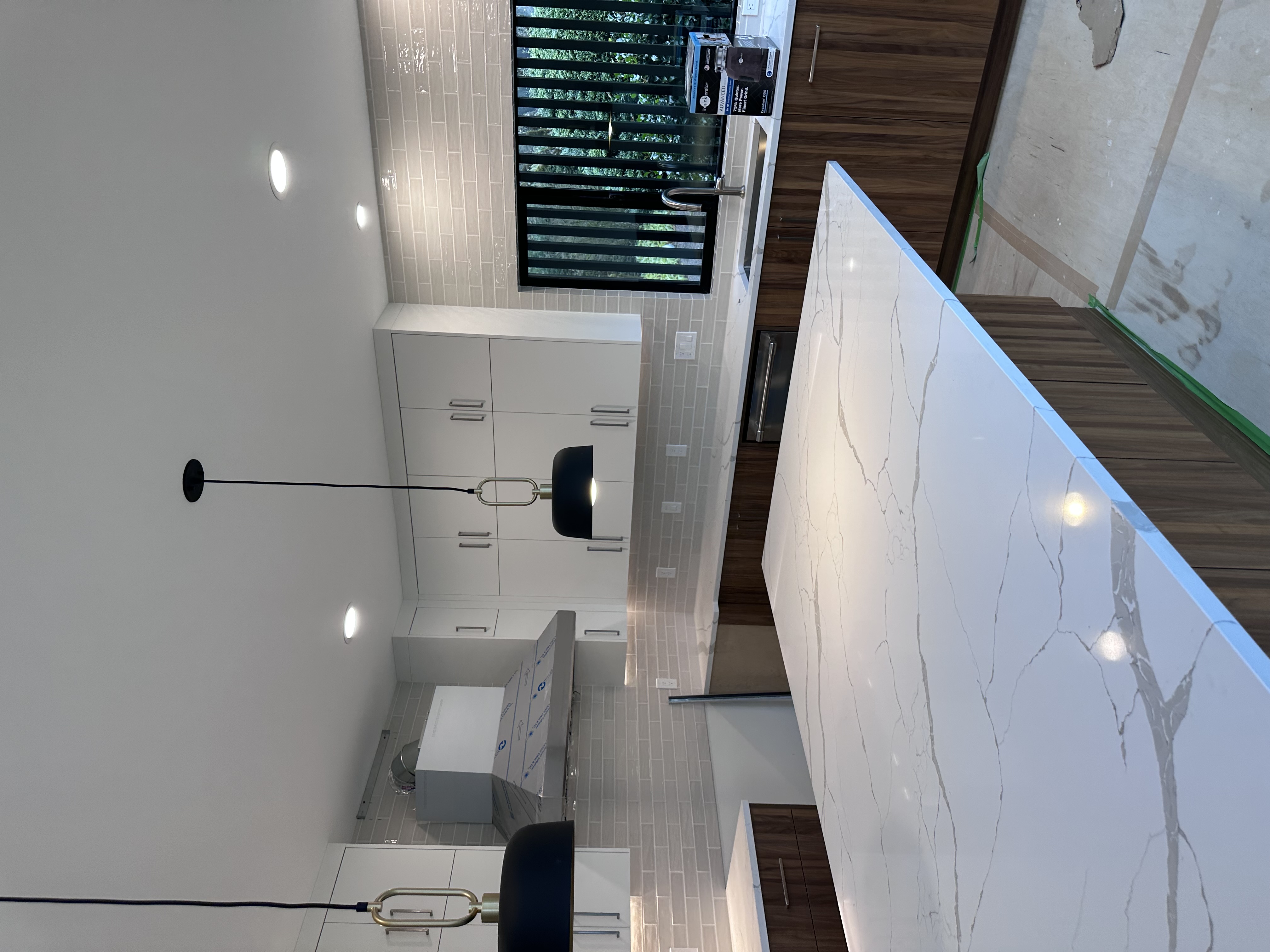 Custom kitchen electrical installation with range hood lights and illuminated backsplash