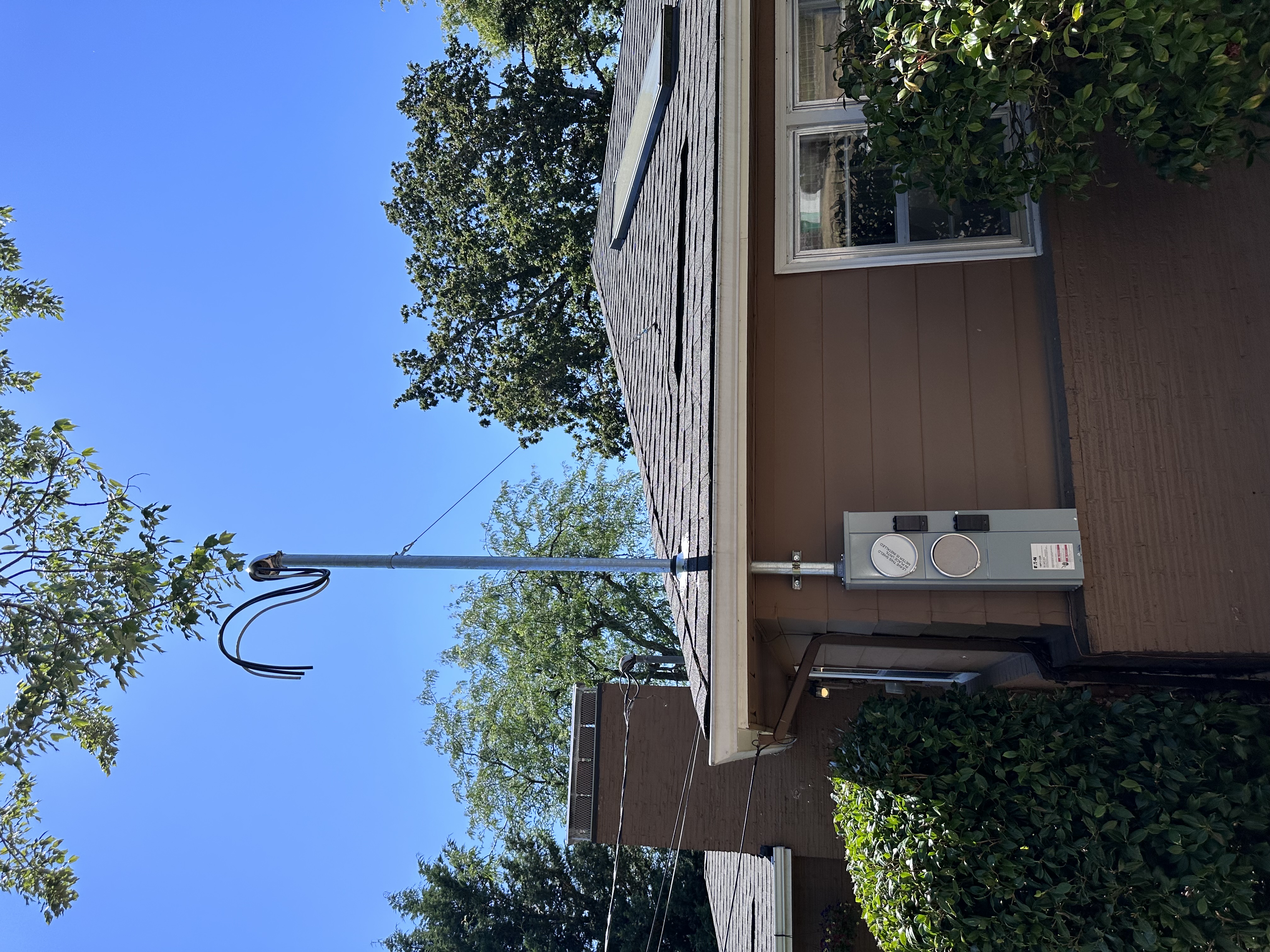 Residential electrical service mast and meter equipment installation