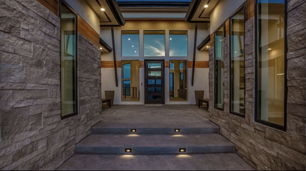 Modern custom home entrance with recessed exterior lighting